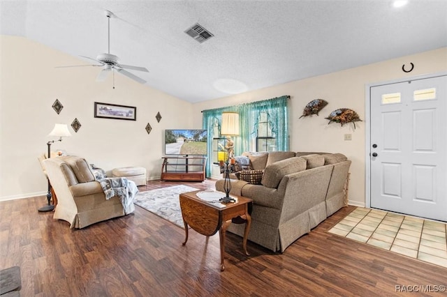 living room featuring vaulted ceiling, ceiling fan, a textured ceiling, and hardwood / wood-style floors