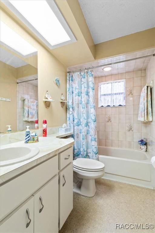 full bathroom with toilet, vanity, and shower / bathtub combination with curtain