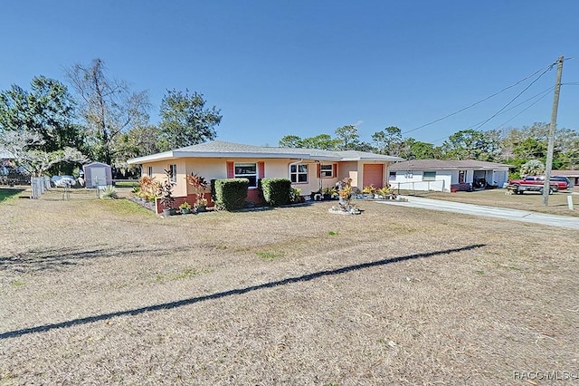 view of front of house with a storage unit