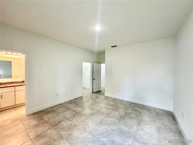 unfurnished bedroom featuring connected bathroom