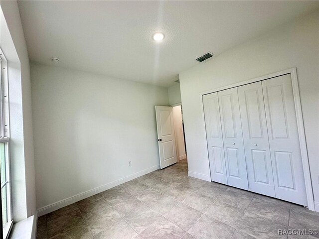 unfurnished bedroom featuring a closet