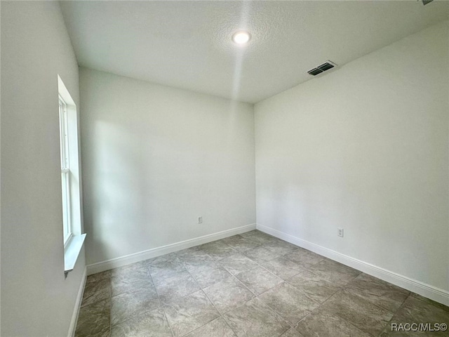 spare room featuring a textured ceiling