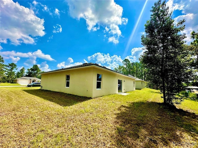 view of side of property with a yard