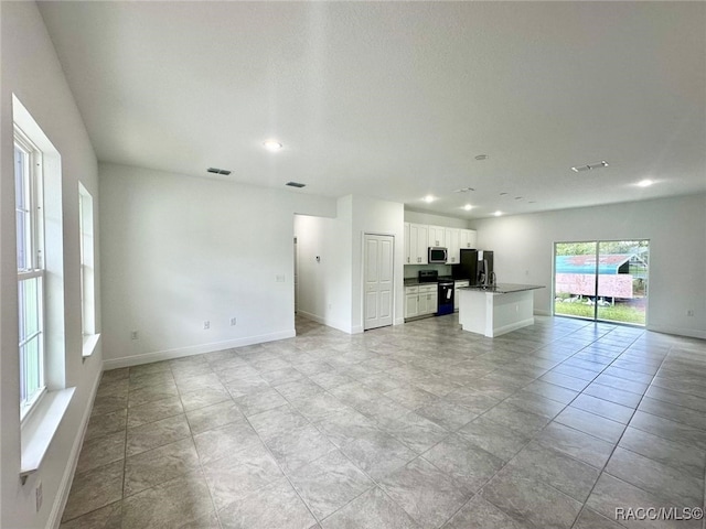 unfurnished living room featuring light tile patterned floors