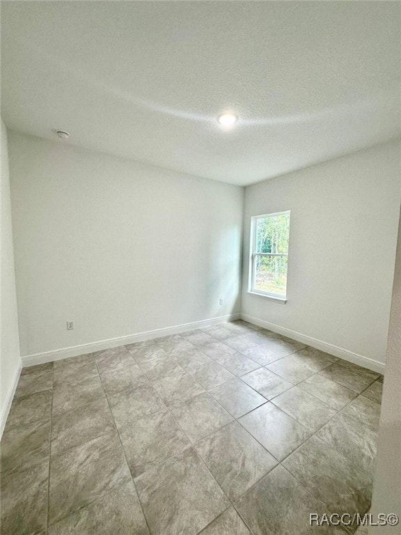 empty room with a textured ceiling