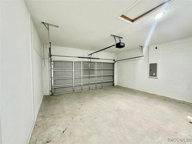 garage featuring electric panel and a garage door opener