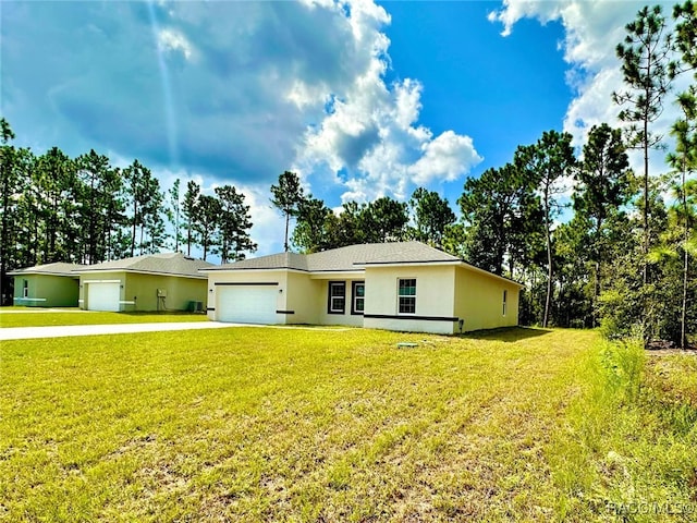 ranch-style home featuring a front lawn and a garage