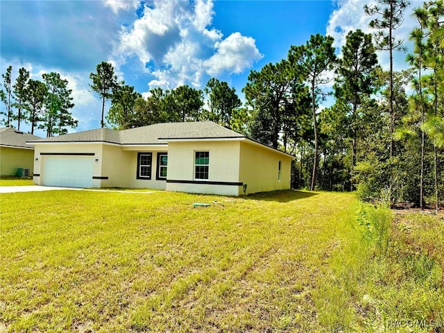 single story home featuring a front lawn and a garage