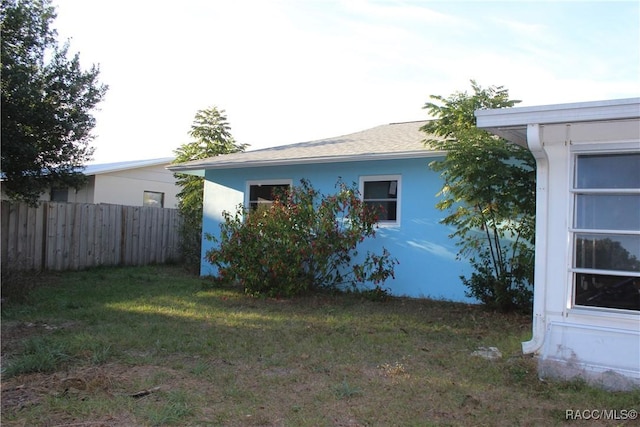 view of home's exterior with a yard