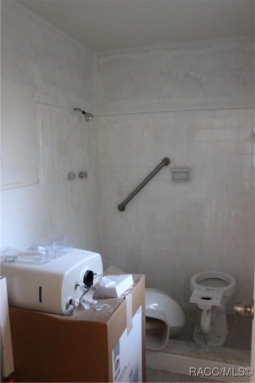 bathroom featuring vanity and tile walls