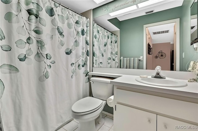 bathroom featuring toilet, vanity, visible vents, and tile patterned floors