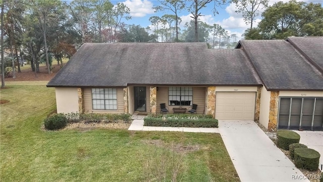 multi unit property featuring a garage, driveway, stone siding, and a front yard