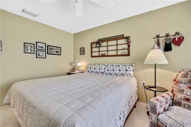 bedroom featuring a ceiling fan, visible vents, and light colored carpet