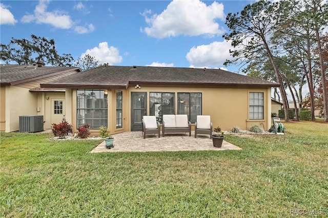 rear view of house featuring a yard, central AC, a patio, and stucco siding