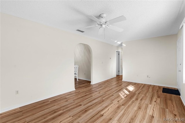 unfurnished room with ceiling fan, a textured ceiling, and light hardwood / wood-style flooring