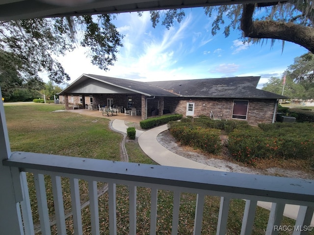 ranch-style home with a patio and a front lawn