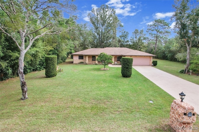 single story home featuring a garage and a front yard