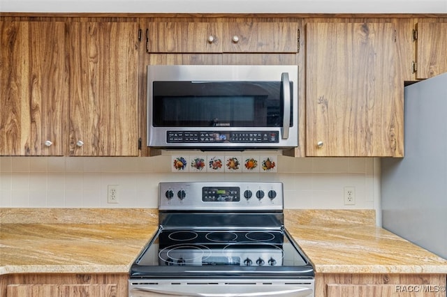 kitchen featuring decorative backsplash and appliances with stainless steel finishes