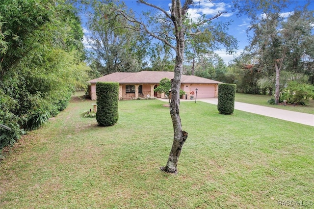 ranch-style house featuring a garage and a front yard