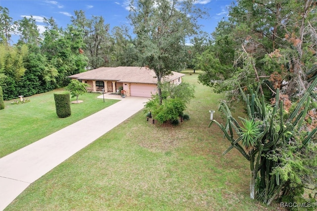 view of front of house featuring a garage and a front lawn