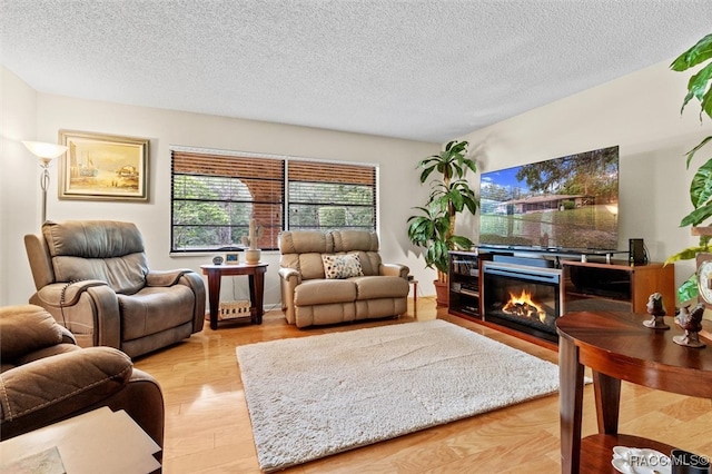 living room featuring a textured ceiling and light hardwood / wood-style floors