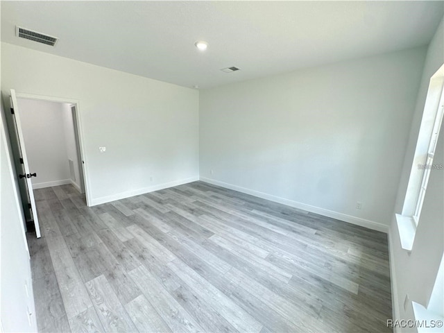 unfurnished room with light wood-type flooring