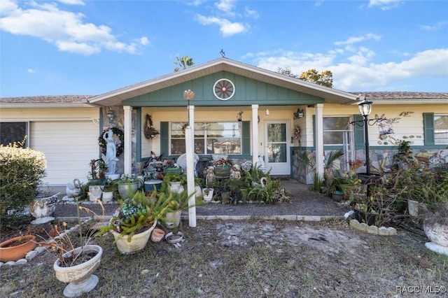 view of front facade featuring covered porch and a garage