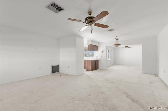 unfurnished living room with ceiling fan and light carpet