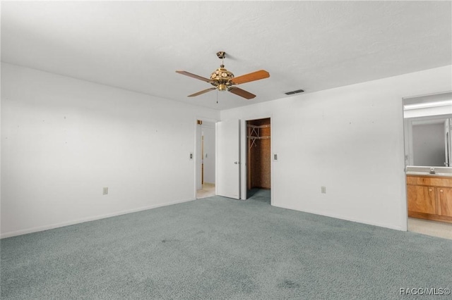 spare room featuring ceiling fan, light colored carpet, and sink