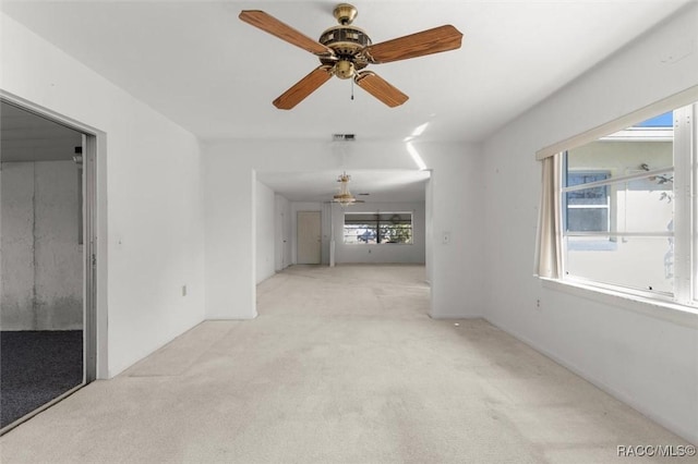 carpeted spare room with ceiling fan