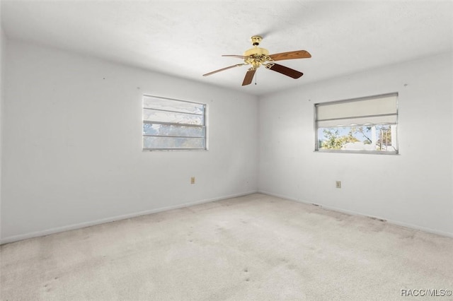 unfurnished room featuring light carpet and ceiling fan