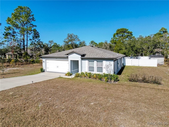 single story home featuring a garage and a front yard