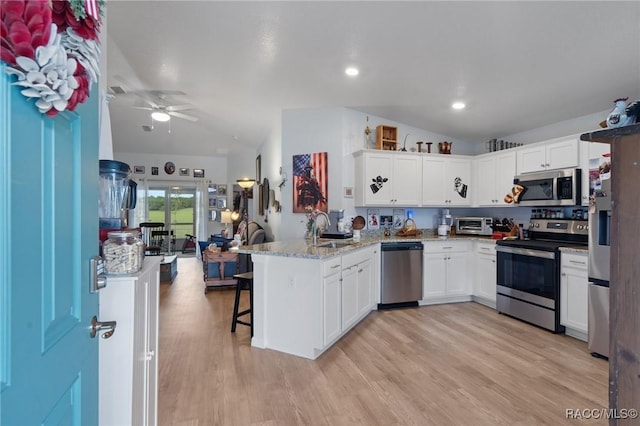 10541 S Drew Bryant Cir, Floral City, FL 34436 - kitchen with a sink, open floor plan, white cabinets, a peninsula, and appliances with stainless steel finishes
