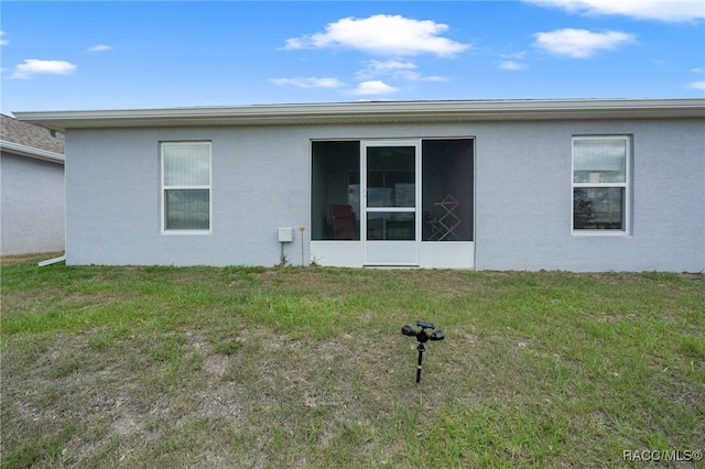 10541 S Drew Bryant Cir, Floral City, FL 34436 - back of house featuring a yard and stucco siding
