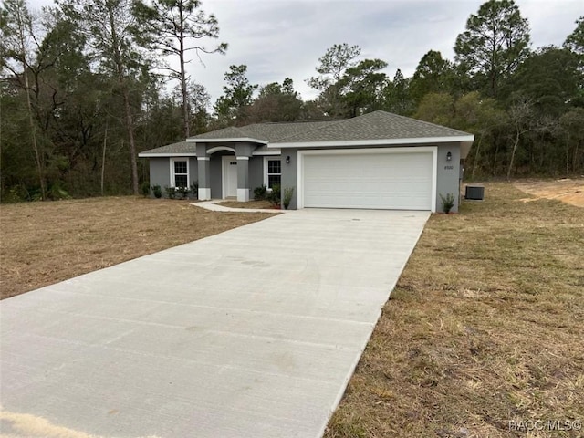 single story home with a garage and a front yard