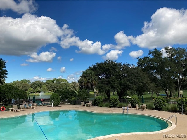 view of swimming pool with a patio area