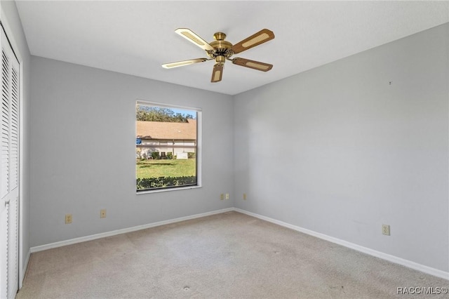 carpeted empty room featuring ceiling fan