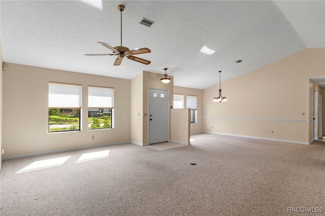 unfurnished living room featuring vaulted ceiling, ceiling fan with notable chandelier, and light colored carpet