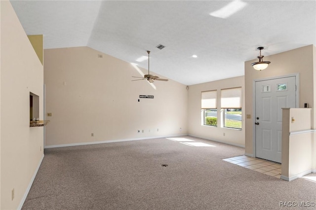 carpeted entryway featuring ceiling fan and vaulted ceiling