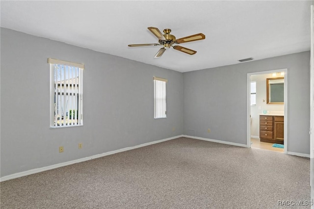 carpeted empty room featuring ceiling fan