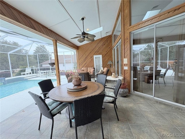 sunroom / solarium with ceiling fan and lofted ceiling