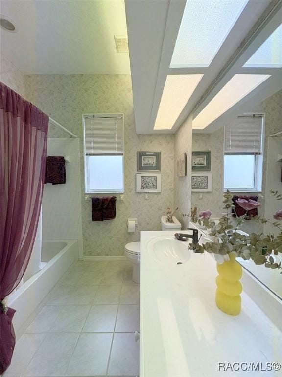 full bathroom featuring toilet, vanity, tile patterned flooring, and shower / bath combination with curtain