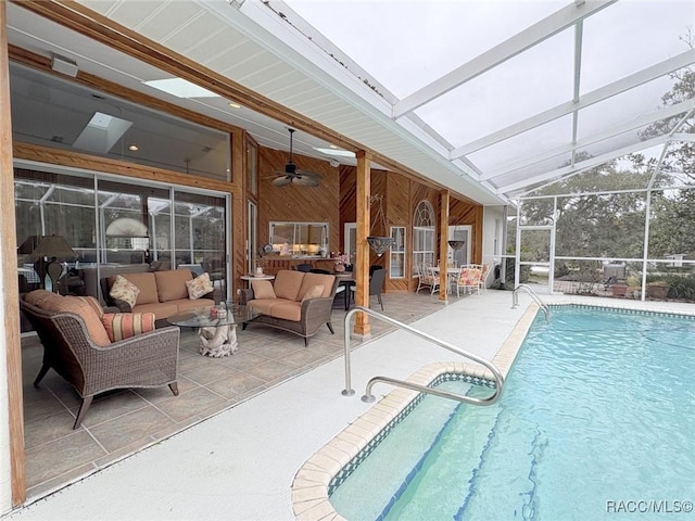 view of swimming pool featuring a lanai, ceiling fan, outdoor lounge area, and a patio