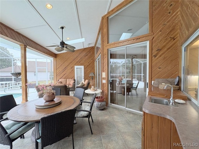 sunroom / solarium featuring ceiling fan and sink