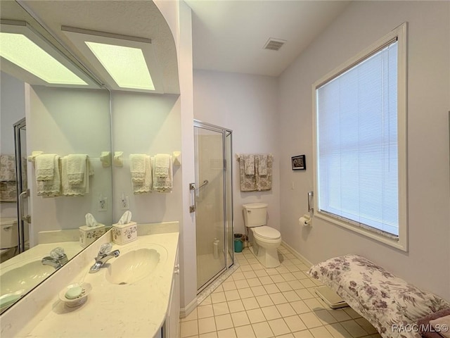 bathroom featuring toilet, tile patterned floors, an enclosed shower, and vanity