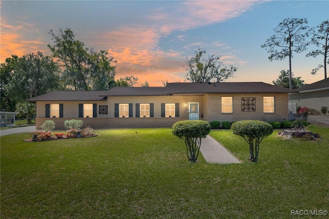 ranch-style house featuring a front lawn