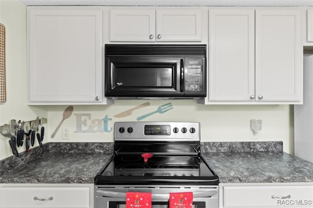 kitchen featuring electric range and white cabinetry