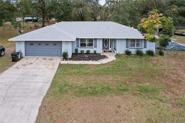 single story home with a front yard and a garage