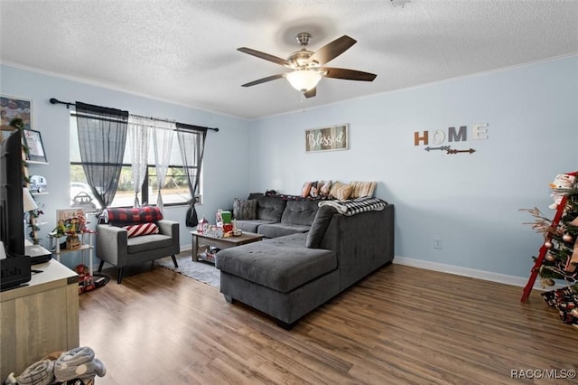 living room with a textured ceiling, ornamental molding, and dark wood-type flooring