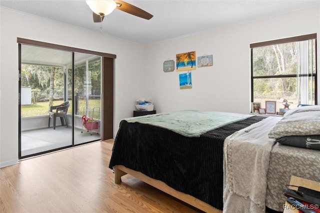 bedroom with access to exterior, light wood-type flooring, ceiling fan, and ornamental molding